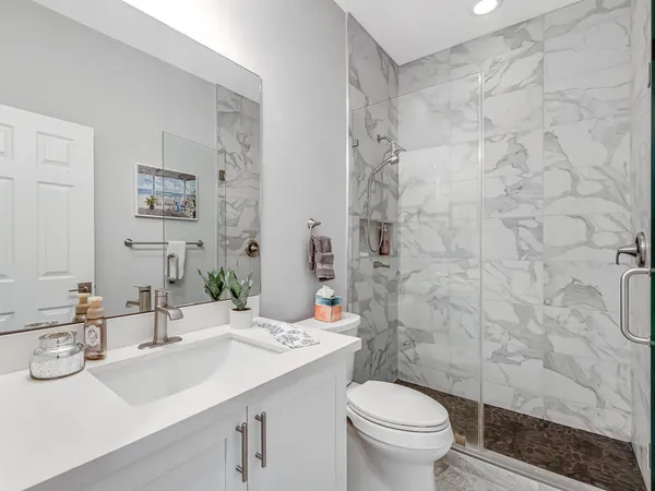 a bathroom with a sink toilet and shower