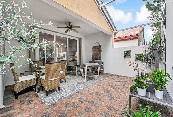 a outdoor space with the couches and a potted plant