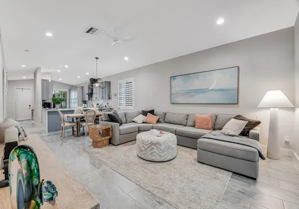 a living room with furniture and a lamp