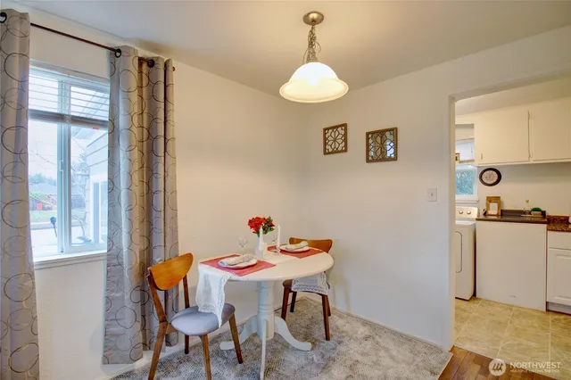 a view of a dining room with furniture and window