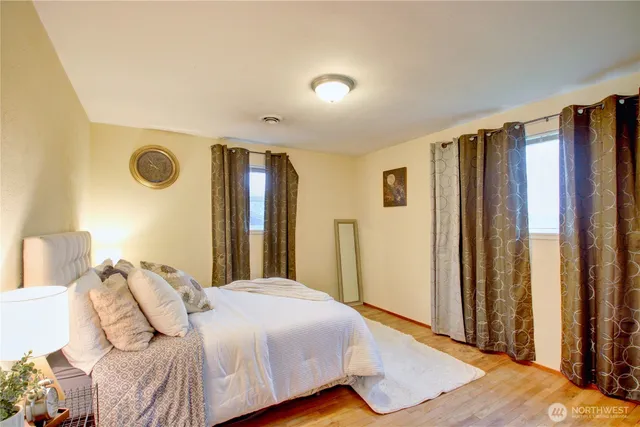 a bedroom with a bed and a window