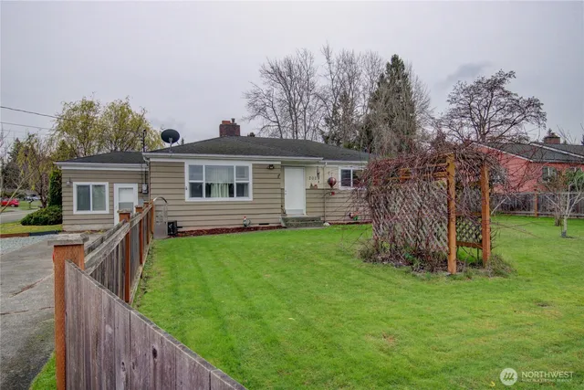 a view of a house with a yard and deck