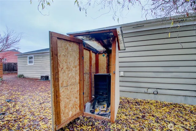 a view of a house with a yard and wooden fence