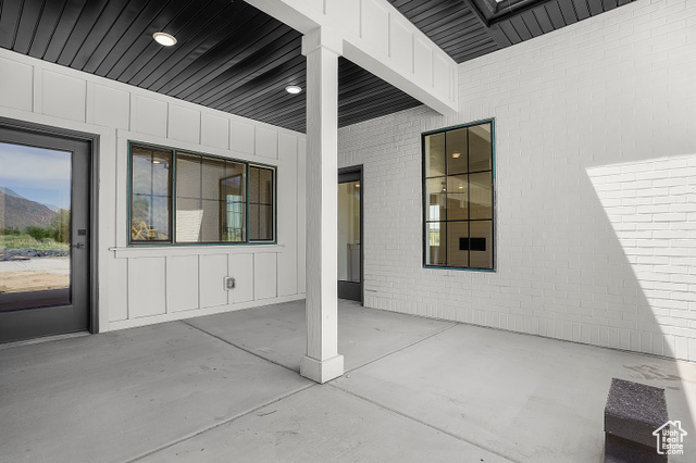 1631 West Century Lane, Unit B Mapleton, UT 84664 - Photo 22 of 33 Doorway to property with a patio area, board and batten siding, a mountain view, and brick siding