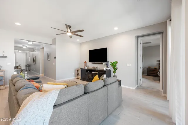 a bedroom with furniture and a flat screen tv