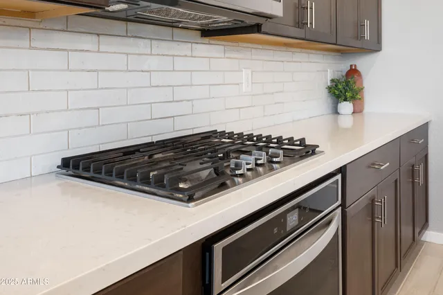 a close view of a stove a microwave and cabinets
