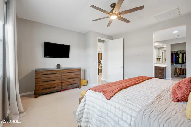a bed room with a bed and a flat screen tv