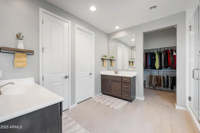a large white kitchen with a sink and dishwasher