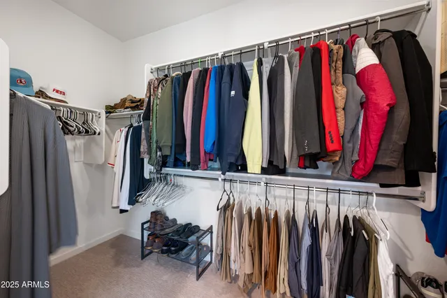 a view of walk in closet with clothes