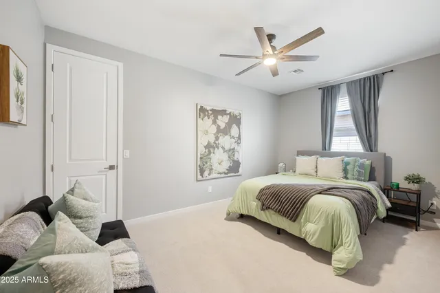 a bedroom with a bed and a chandelier