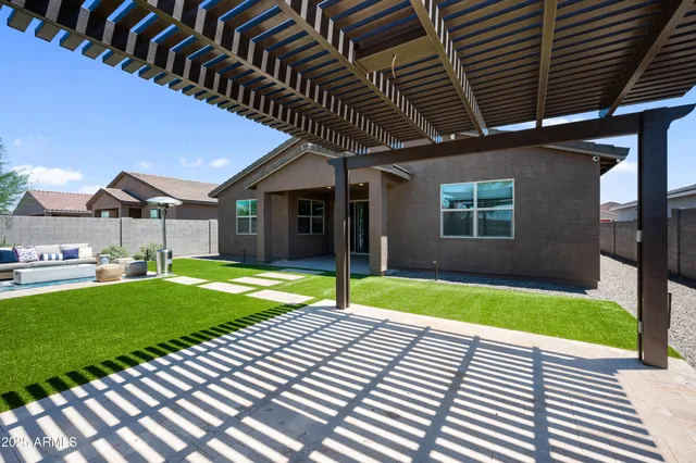 a kitchen with stainless steel appliances a dining table chairs refrigerator and microwave
