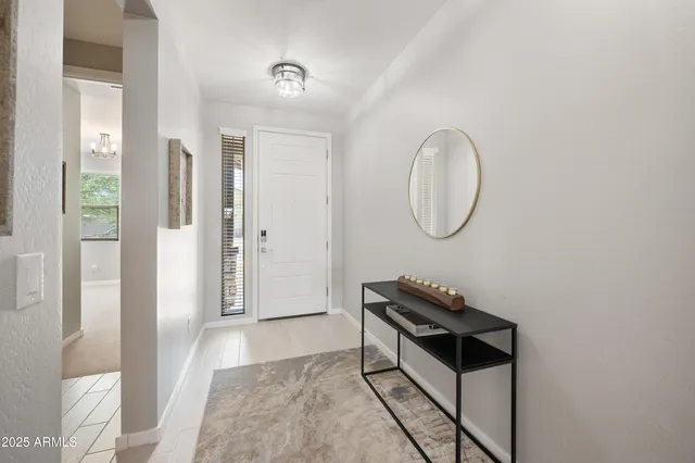 a view of a livingroom with wooden floor and a potted plant