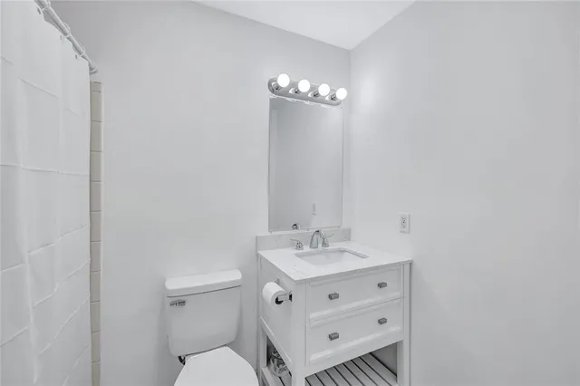 a view of a room with wooden floor and windows