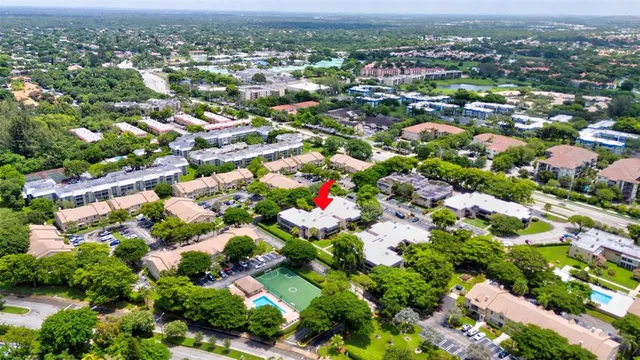 an aerial view of residential houses with outdoor space and trees
