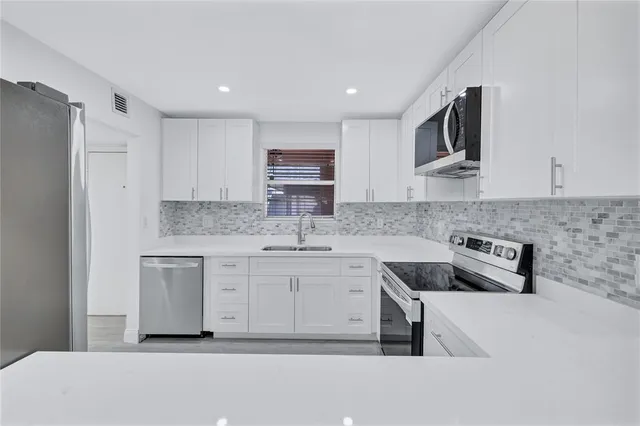 a kitchen with a refrigerator and sink