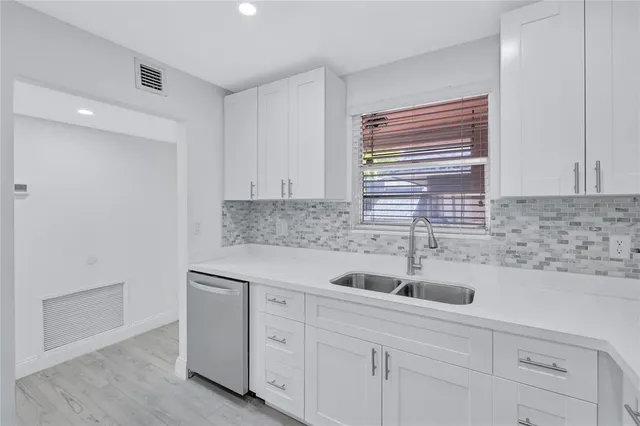 a kitchen with a sink stove and refrigerator