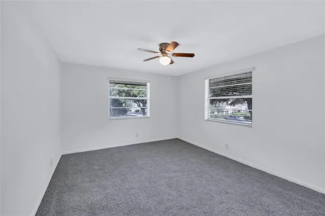 a bathroom with a granite countertop sink a mirror and shower