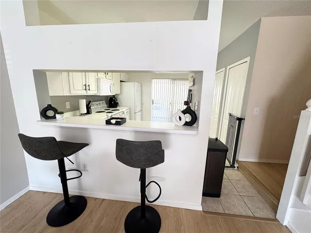 a kitchen with stainless steel appliances kitchen island granite countertop a refrigerator a stove a sink and dishwasher