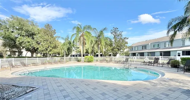 a view of a swimming pool with a house in the background