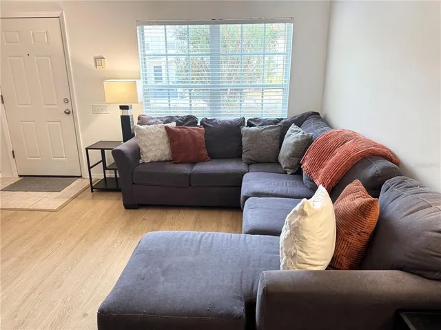 a living room with furniture and a large window