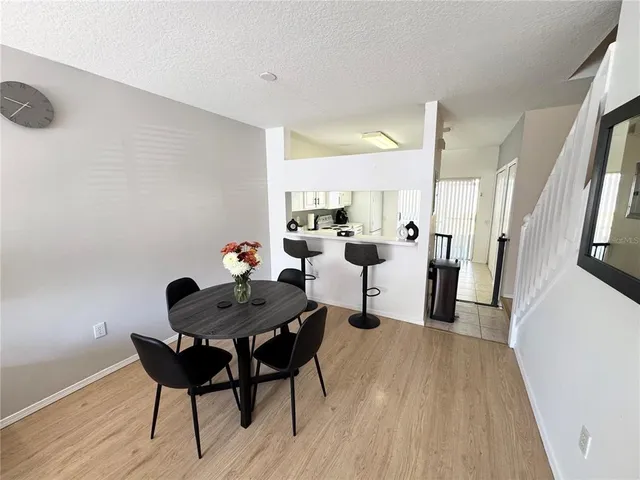 a dining room with furniture and wooden floor