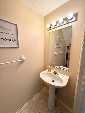 a bathroom with a sink a mirror and a toilet