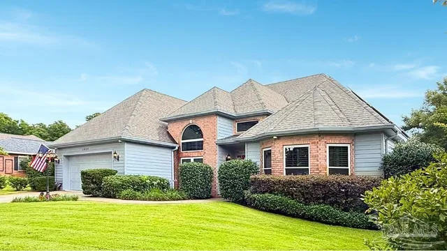 a living room with furniture a large window and a chandelier