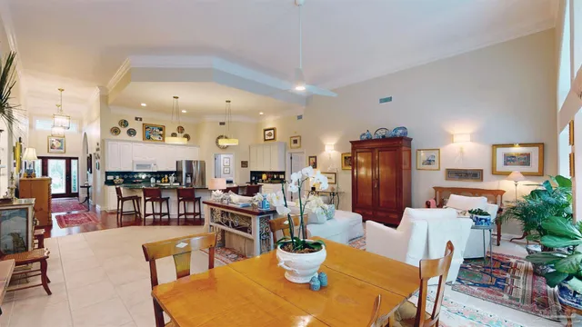 a kitchen with stainless steel appliances a dining table chairs and wooden floor