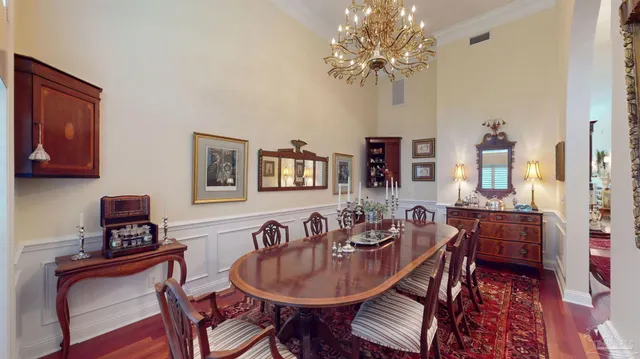 a spacious bedroom with a bed chandelier and a window