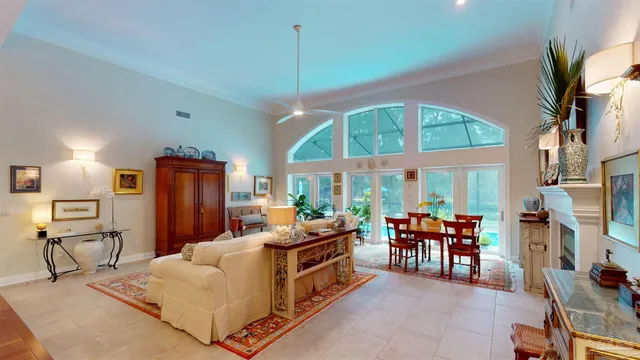 a living room with furniture a fireplace and a kitchen view