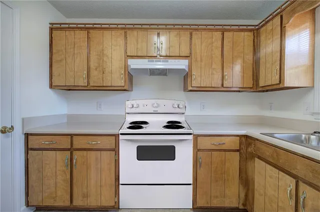 a kitchen with a stove top oven