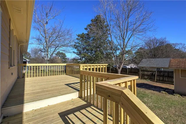 a view of a deck with chairs and wooden floor