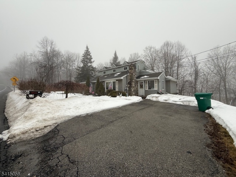 38 Highland Lakes Road Vernon, NJ 07462 - Photo 4 of 21 a view of a house with a snow on the road