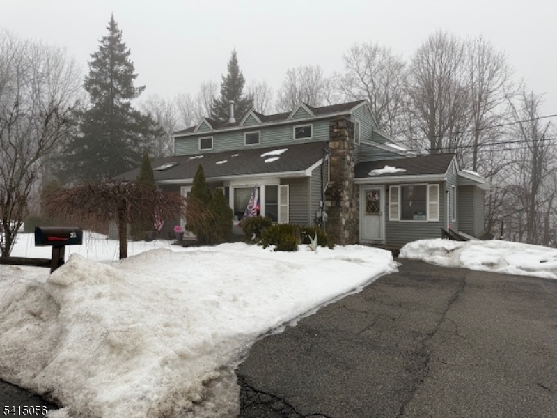 38 Highland Lakes Road Vernon, NJ 07462 - Photo 5 of 21 a view of a building with snow on the road