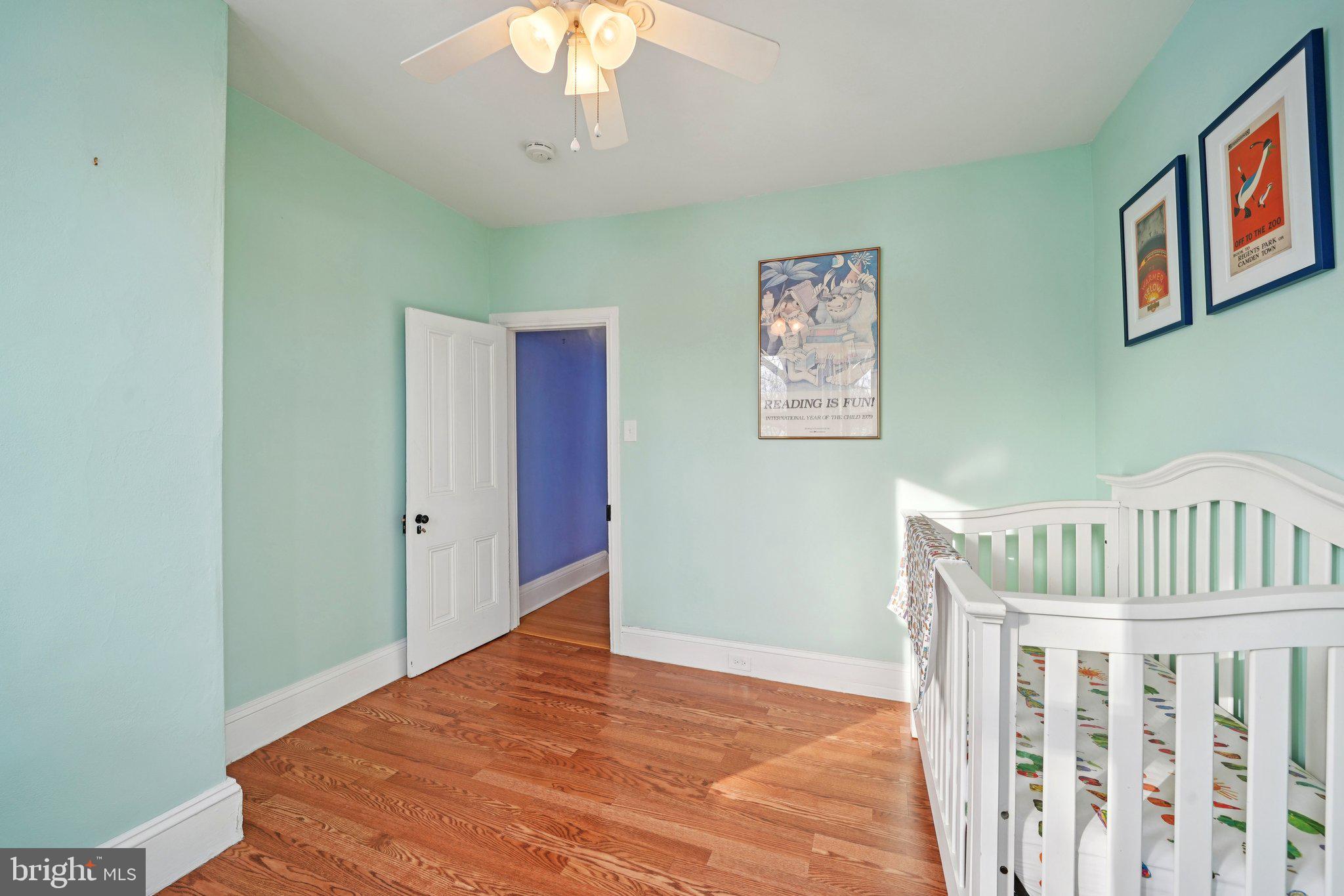 3008 Poplar Street Philadelphia, PA 19130 - Photo 30 of 50 a bedroom with a bed and a chandelier