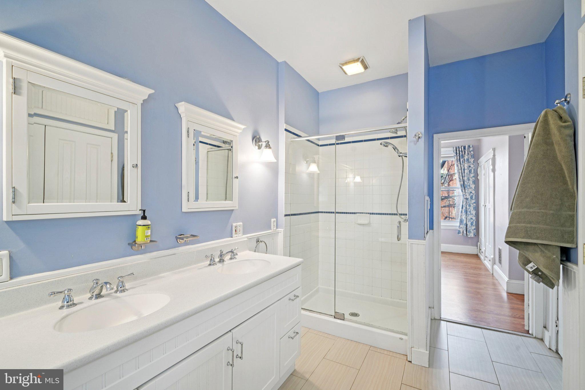 3008 Poplar Street Philadelphia, PA 19130 - Photo 36 of 50 a bathroom with a double vanity sink a mirror and shower