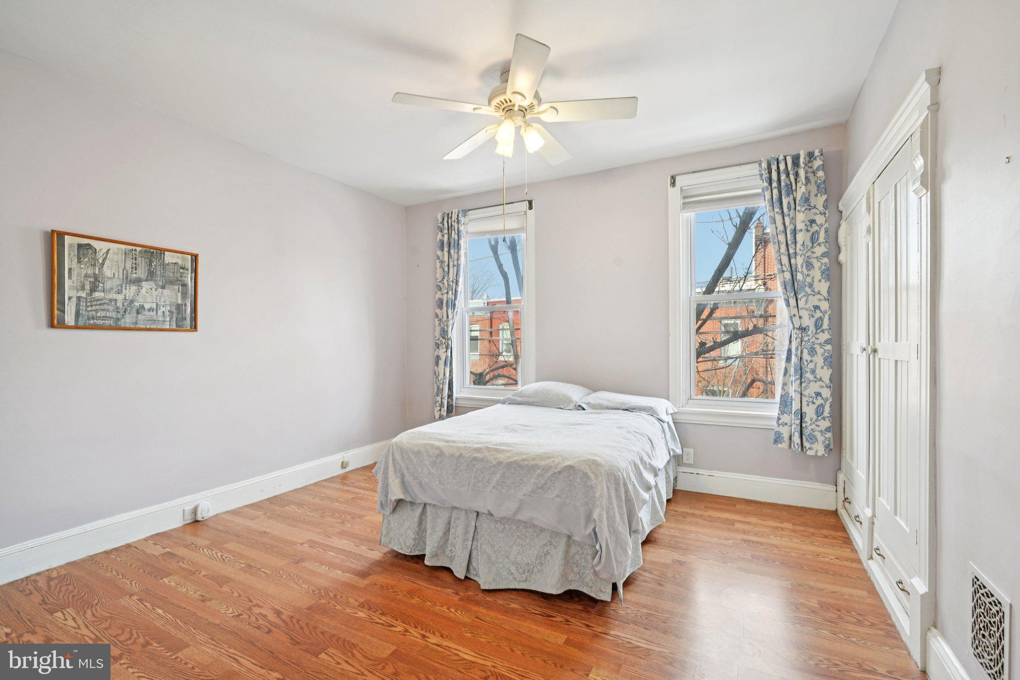 3008 Poplar Street Philadelphia, PA 19130 - Photo 37 of 50 a bedroom with a large bed and a chandelier