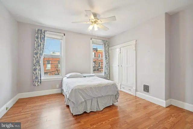 a bedroom with a large bed and a chandelier