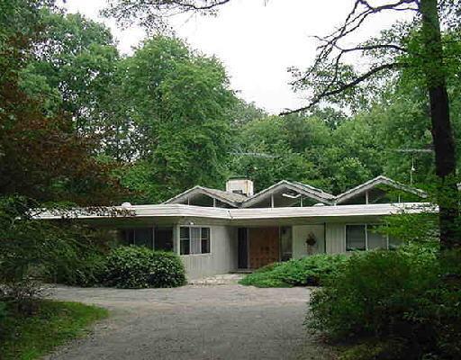 1021 Ridgefield Road Wilton, CT 06897 - Photo 1 of 1 a front view of a house with a yard