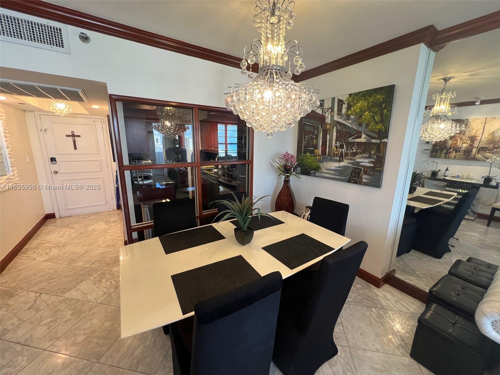 100 Lincoln Road, Unit 1633 Miami Beach, FL 33139 - Photo 11 of 52 a view of a dining room with furniture and a chandelier