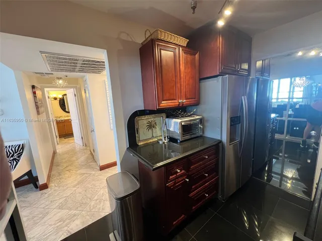 a living room with furniture potted plant and a wooden floor