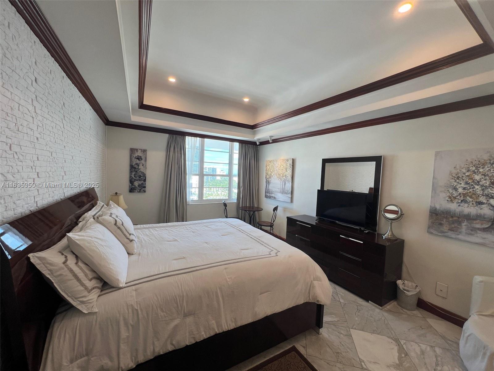 100 Lincoln Road, Unit 1633 Miami Beach, FL 33139 - Photo 15 of 52 a bedroom with a bed and wooden floor