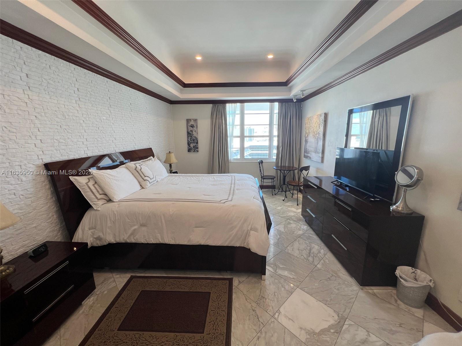 100 Lincoln Road, Unit 1633 Miami Beach, FL 33139 - Photo 17 of 52 a bed sitting in a room next to a window