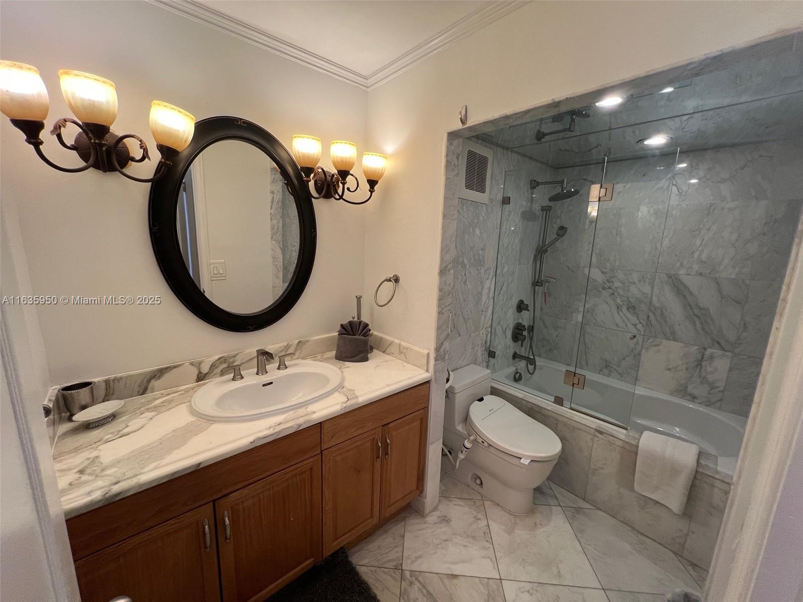 100 Lincoln Road, Unit 1633 Miami Beach, FL 33139 - Photo 20 of 52 a bathroom with a double vanity sink toilet mirror and shower