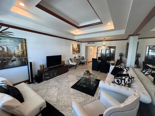 a living room with lots of furniture and a chandelier