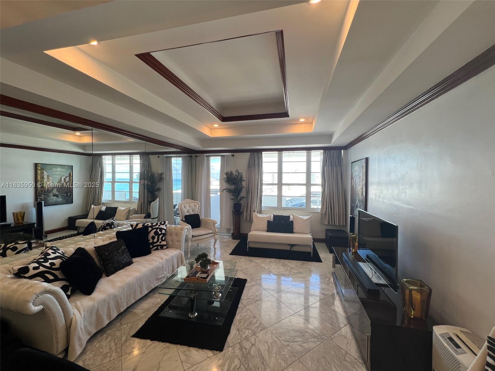 100 Lincoln Road, Unit 1633 Miami Beach, FL 33139 - Photo 7 of 52 a living room with furniture and a flat screen tv