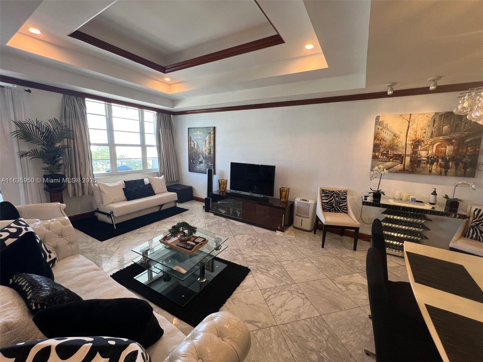 100 Lincoln Road, Unit 1633 Miami Beach, FL 33139 - Photo 8 of 52 a living room with furniture and a flat screen tv