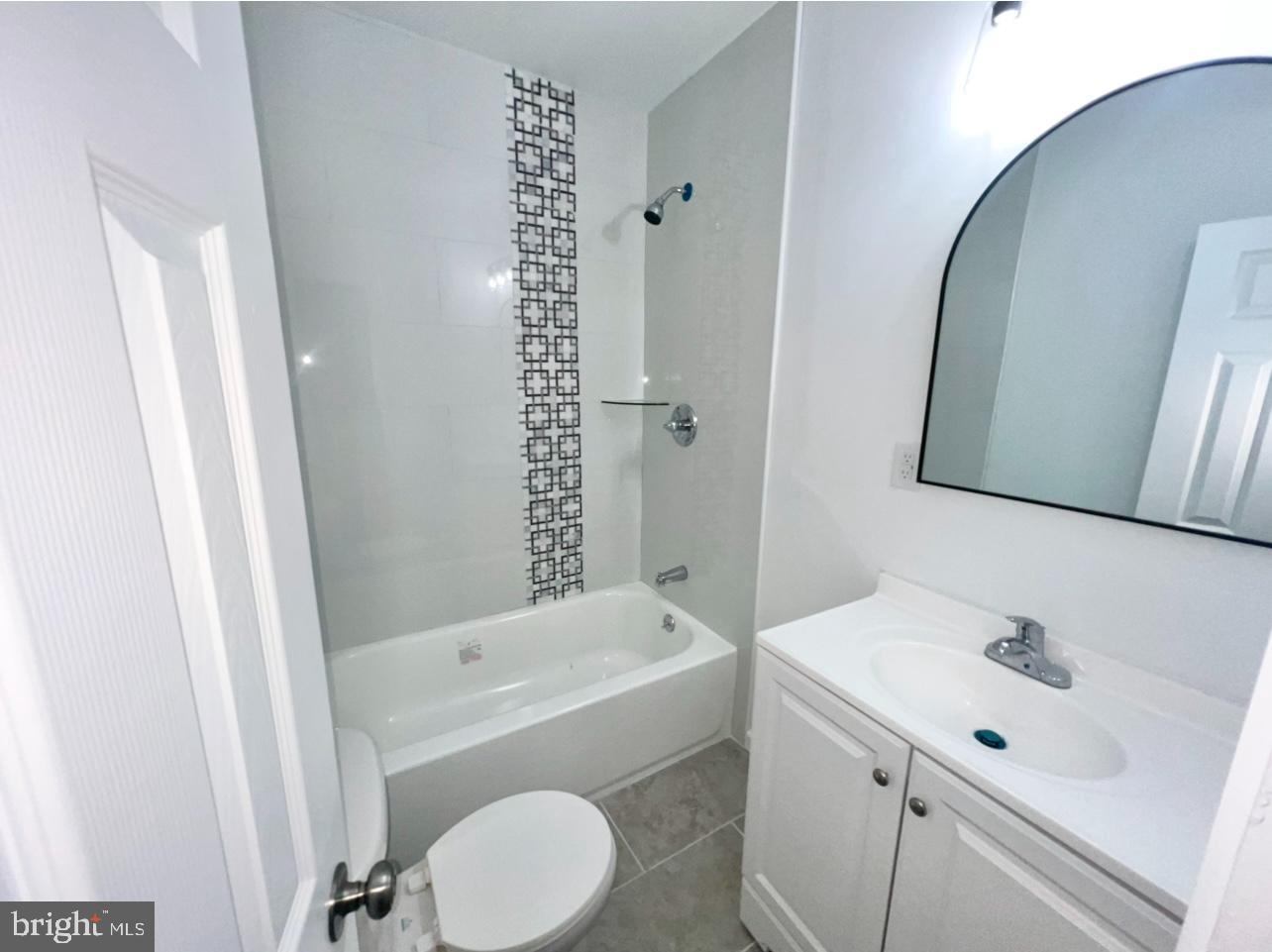 1607 South 60th Street, Unit 1 Philadelphia, PA 19142 - Photo 11 of 16 a bathroom with a sink a toilet and shower