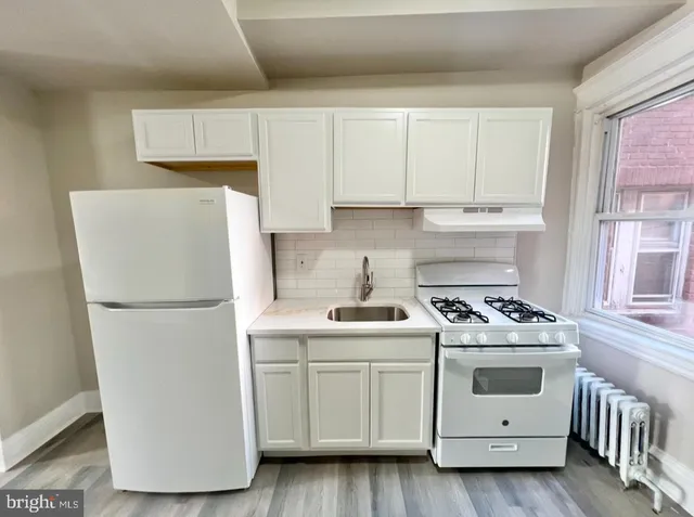 a white refrigerator freezer sitting inside of a kitchen