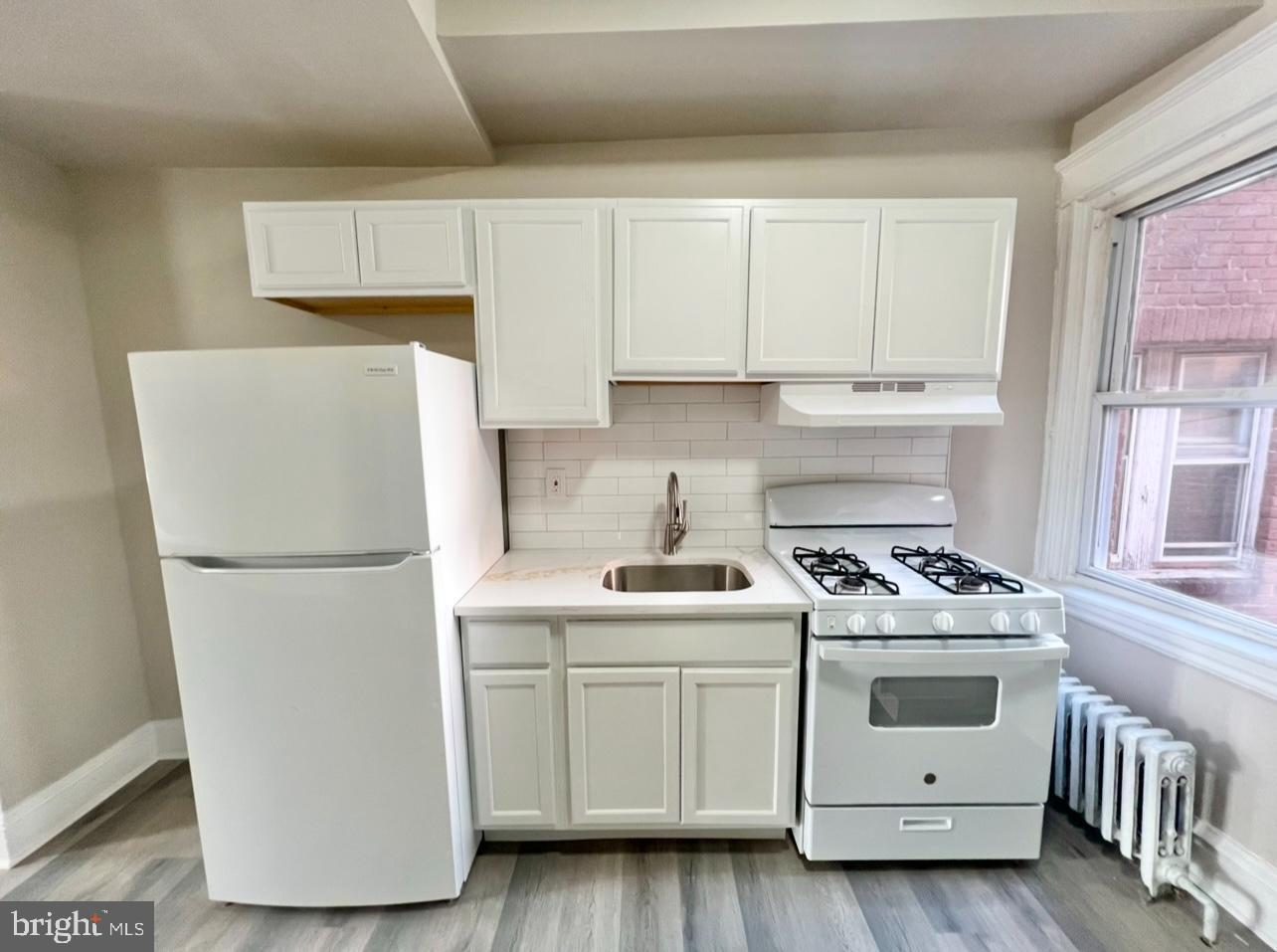 1607 South 60th Street, Unit 1 Philadelphia, PA 19142 - Photo 10 of 16 a white refrigerator freezer sitting inside of a kitchen